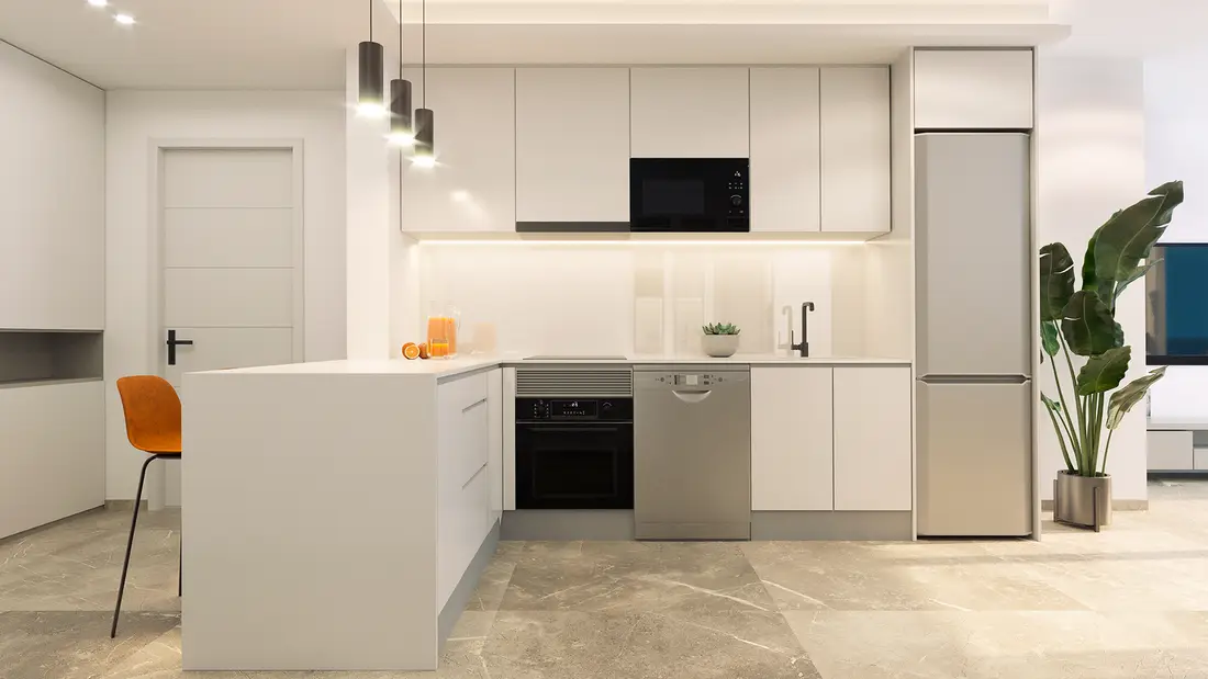 Open kitchen of a two-bedroom apartment at Rodas Playa, with anthracite units and a stone-effect worktop