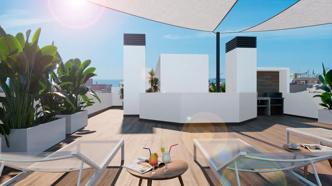 The community solarium on the roof of Rodas Playa: timber decking, white parapets, shade sails and the sea between the buildings
